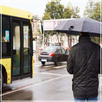 man approaching bus in the rain