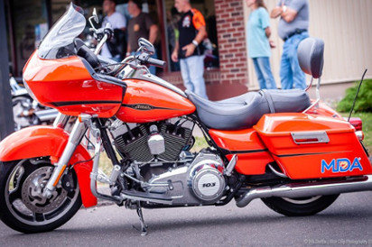 Orange motorcycle with MDA logo 