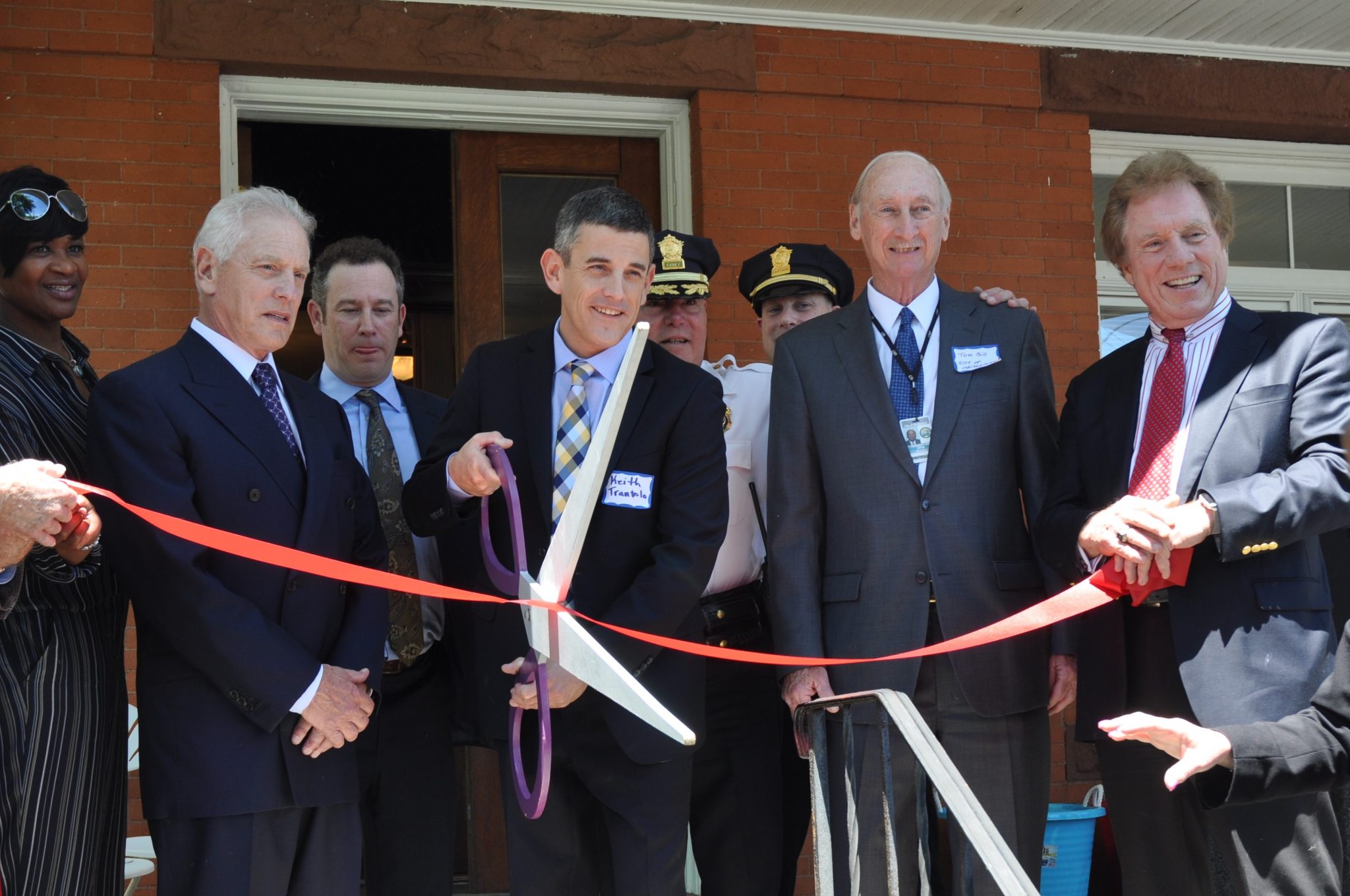 Vincent, Keith and Scott Trantolo cutting ribbon at new office