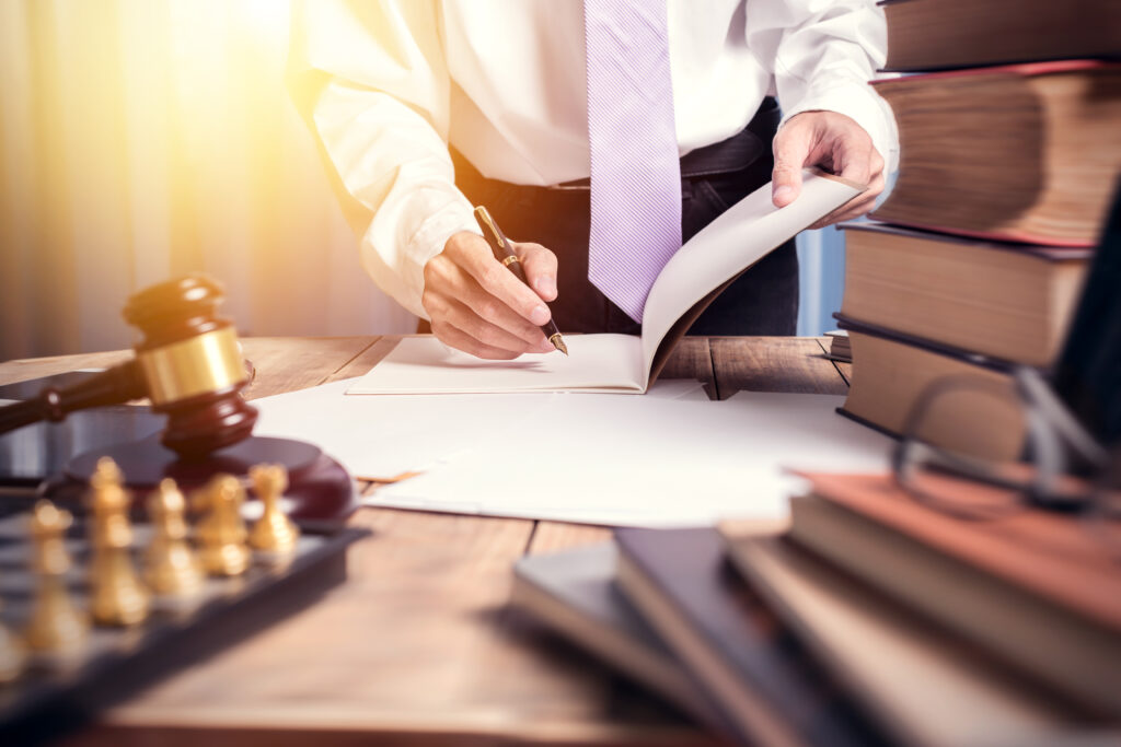 Young lawyer working with paperwork on his desk 