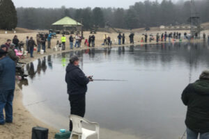 group of people fishing on the lake