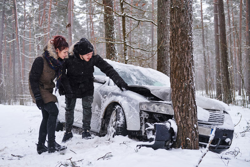 crashed car after accident snowy forest